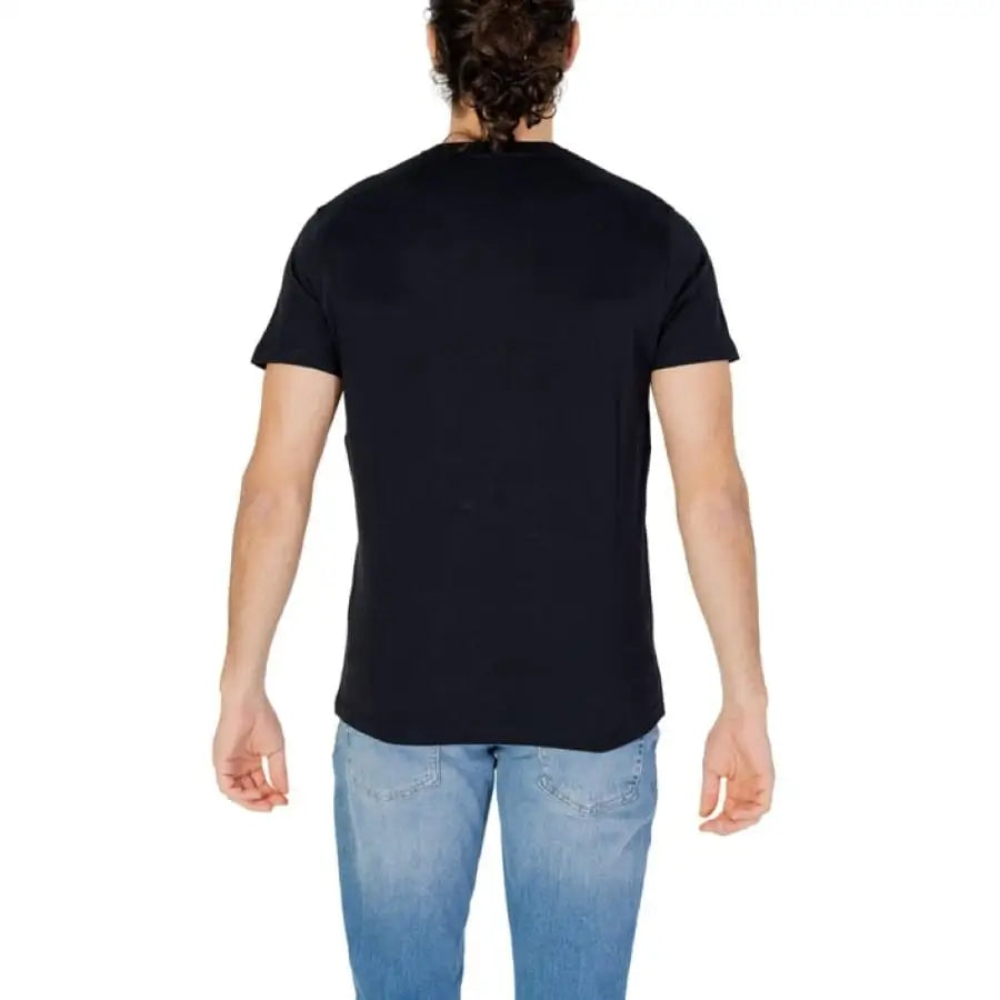 Man wearing U.S. Polo Assn. men t-shirt and jeans showcasing apparel accessories.