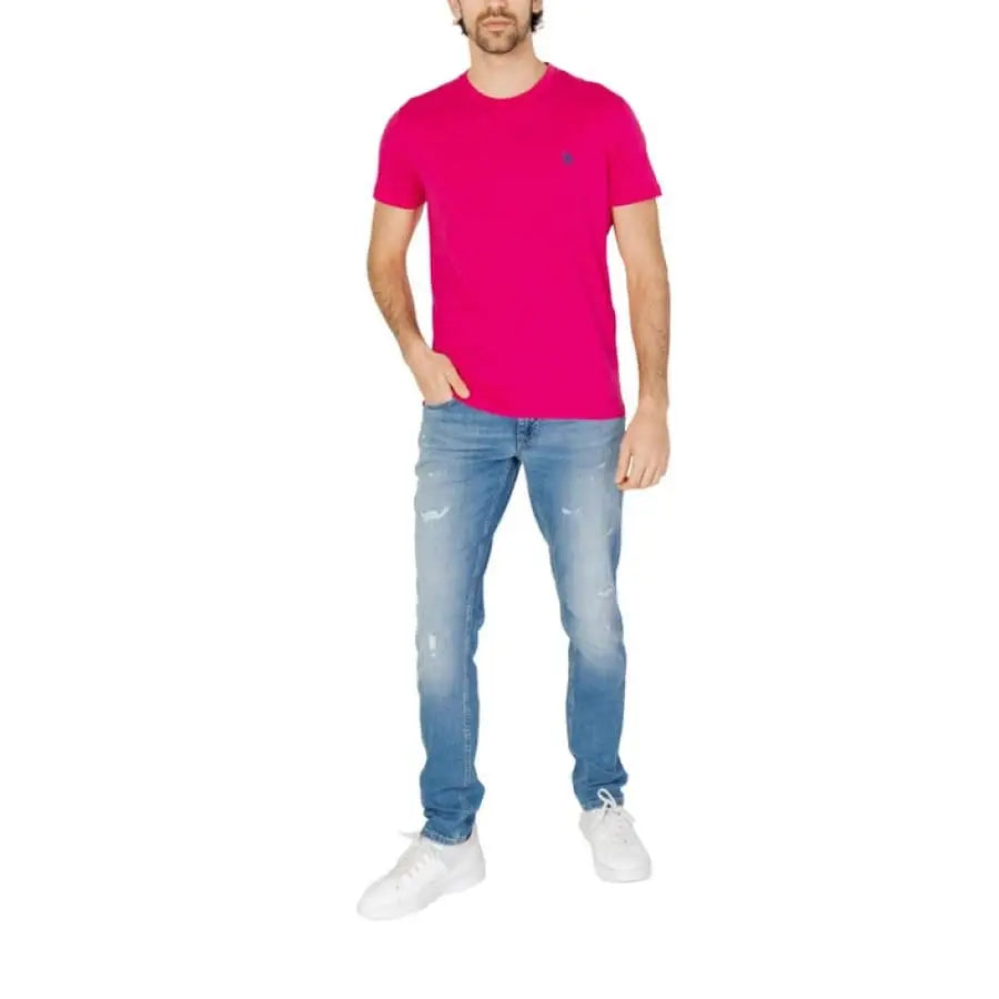 Man modeling U.S. Polo Assn. men t-shirt in pink with jeans, apparel accessories.