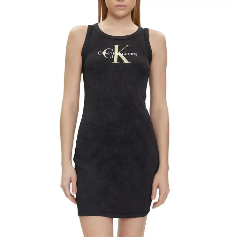 A woman in a black Calvin Klein dress with a ’K’ displayed; Calvin Klein Jeans Collection