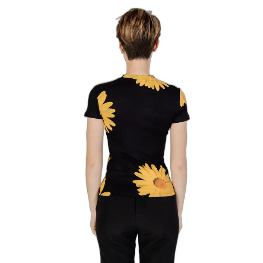 Desigual women t-shirt featuring a woman in a black top with yellow flowers