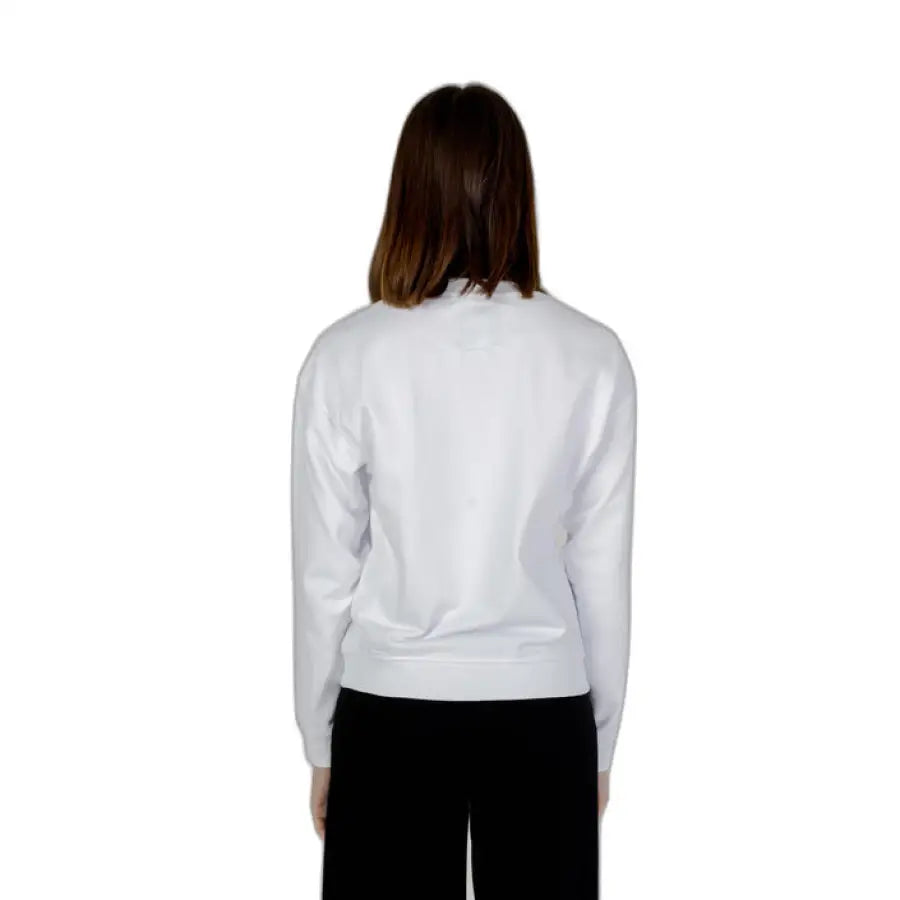 
                      
                        Armani Exchange woman in white sweatshirt and black pants for Armani Exchange product
                      
                    