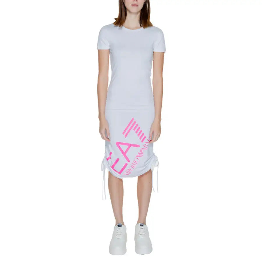 Woman wearing white t-shirt and skirt with pink logo, urban style - EA7 Women’s Dress