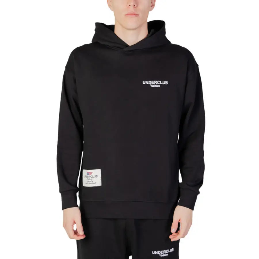 
                      
                        Young man in Underclub urban style black hoodie for city fashion
                      
                    